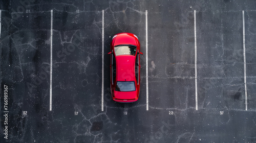 Red car in an empty parking lot, aerial view. Parked car, top view.