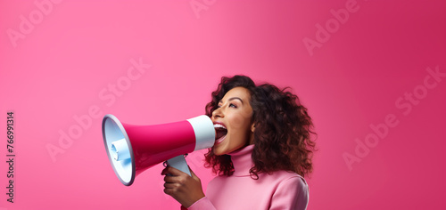 Portrait Of Smiling Woman Shouting With A Megaphone Isolated On Pink Background
