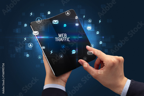 Businessman holding a foldable smartphone, social media concept
