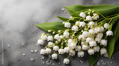 Lily of the Valley flowers with water droplets on marbled surface  photo