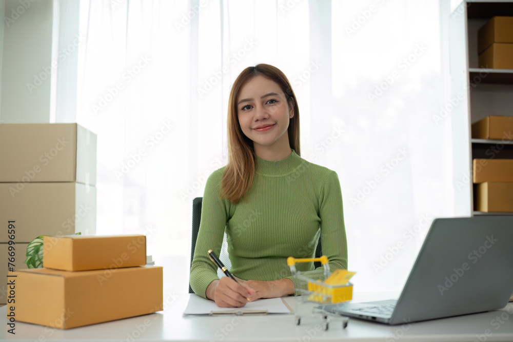 Portrait of Starting small businesses SME owners female entrepreneurs working on receipt box and check online orders to prepare to pack the boxes, sell to customers, SME business ideas online. Portrait of Starting small businesses SME owners female entrepreneurs working on receipt box and check online orders to prepare to pack the boxes, sell to customers, SME business ideas online.