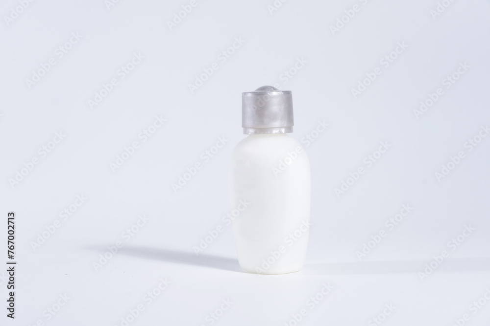 White plastic cosmetic lotion bottle mock-up with cap.on white background White plastic cosmetic lotion bottle mock-up with cap.on white background