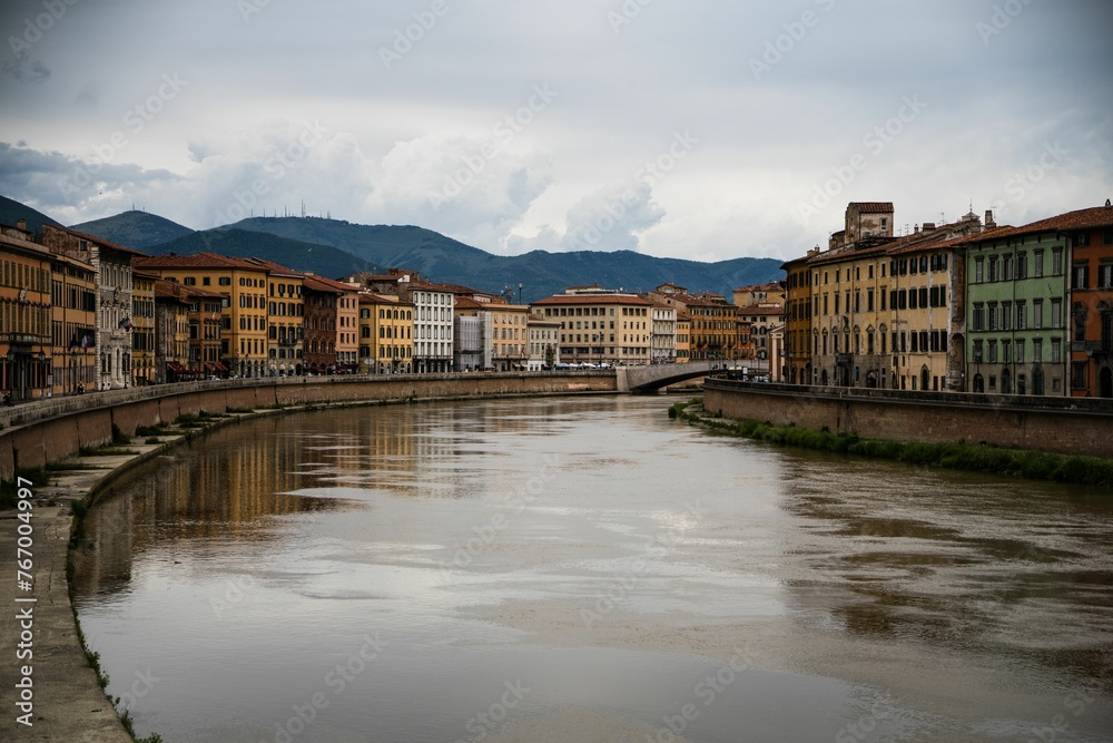 Buildings along an Italian river with mirrored reflections in the water