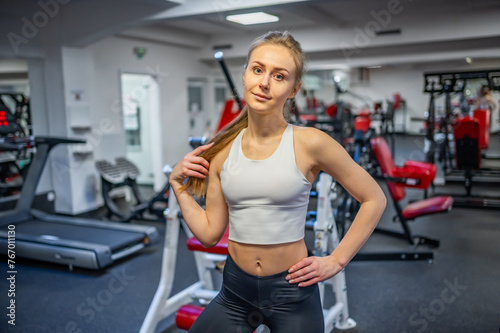 Young sporty woman wearing sportswear posing before doing exercise with fitness equipment at gym, she exercise for strong and good 