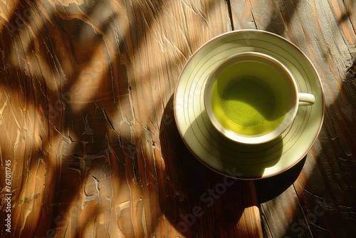 Tea: Cup of green tea Steaming hot On a saucer Top-down shot 