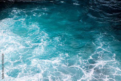 Blue ocean texture with waves and foam