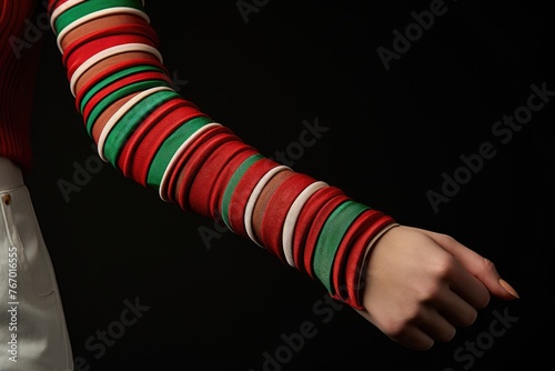 Red and green striped arm warmers.