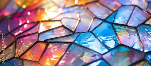 Captivating closeup of a vibrant stained glass window showcasing a mesmerizing pattern of triangles in electric blue hues. A true masterpiece of art and symmetry