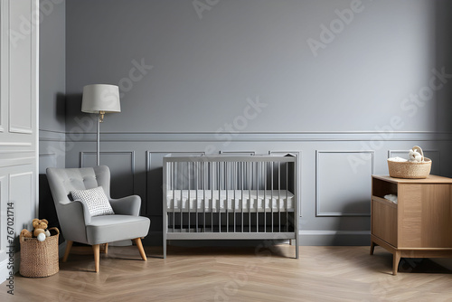 Real photo of a baby crib standing between a low cupboard and an armchair, lamp and stool in child's room interior with wooden floor and grey walls with molding