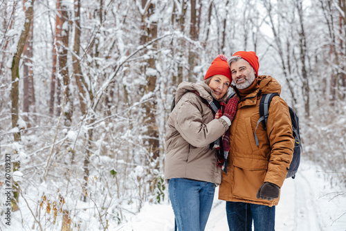 Happy mature couple in a snowy forest