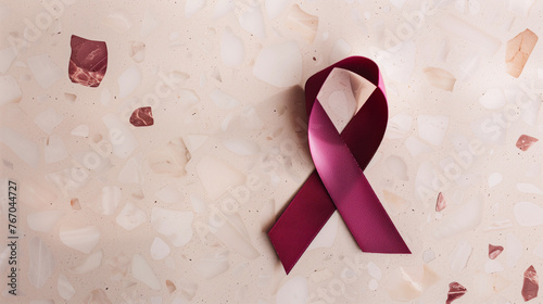 burgundy cancer ribbon simple background support multiple myeloma, antiphospholipid syndrome, amyloidosis sickle cell disease meningitis awareness brain research copy space header medicine photo