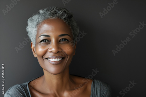 Beautiful elegant mature grey haired middle aged African American woman with perfect skin and smile