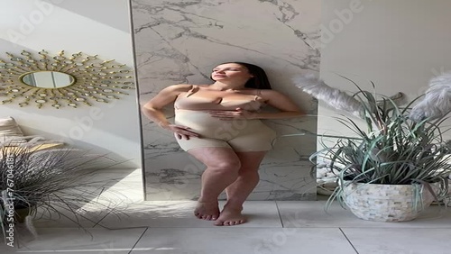 Beautiful pregnant woman in special pregnancy underwear. Advertisement of comfortable basic pregnancy underpants. Happy brunette girl show her panties in hall. Caucausian thin woman