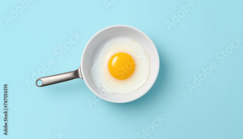 Frying pan with eggs on blue background photo