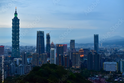 Aerial view of skyline of Taipei city with Taipei 101 Skyscraper at sunset from Xiangshan Elephant Mountain. Beautiful landscape and cityscape of Taipei downtown buildings and architecture in the city © HO