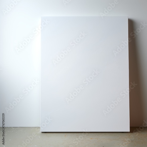 Canvas mockup on the floor in an empty white room with a white wall
