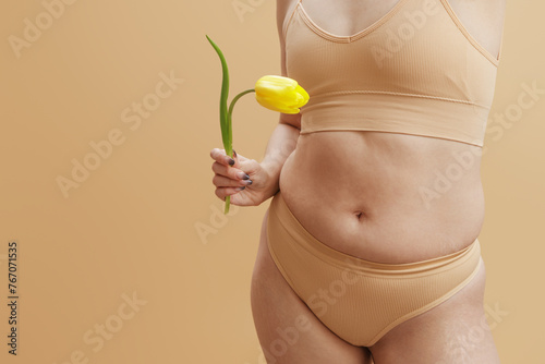 Body imperfections. Real human skin without retouching, acne, stretch marks, cellulite and excess weight. Body Positivity. Photo of chubby overweight woman, poses in lingerie
