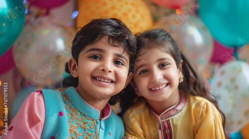  image captures colourfully dressed Muslim children; their faces brightened with joy. Amidst vibrant balloons, they exude eagerness and celebration photo
