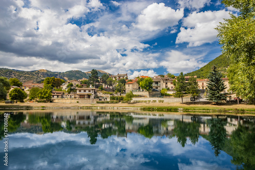 The beautiful village of Villalago, in the province of L'Aquila in Abruzzo, central Italy. The small lake near the town centre, immersed in the nature of the green Abruzzo mountains. © Ragemax