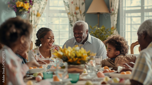 A family gathers around a dining table adorned with flowers and food  sharing a meal in a room bathed in natural light