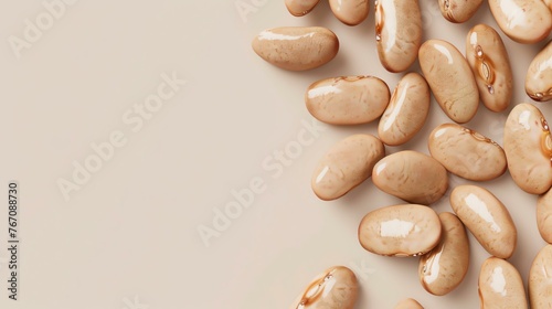 **Image Description:**  A close-up image of a pile of pinto beans. The beans are tan and brown, and they are all different shapes and sizes. photo