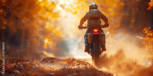 back of man rider on sport enduro motorcycle races on forest at sunset in autumn