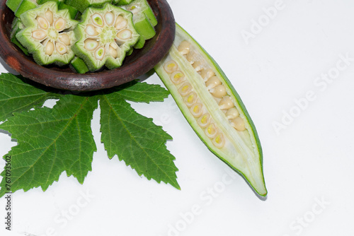 Fresh okra in bowl isolated on white background