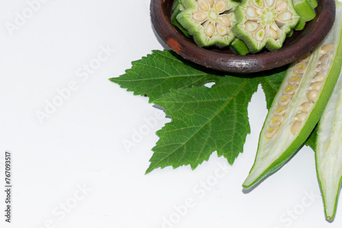Fresh okra in bowl isolated on white background
