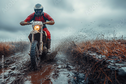 male motorcycle biker racer on sports enduro motorcycle in off-road race rally riding on dirty road in nature © alexkoral
