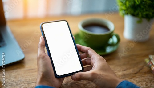 Mobile Phone for Mockup - Mobile Phone held by Hand in an Office or Cafe Environment - Template for Application Presentation