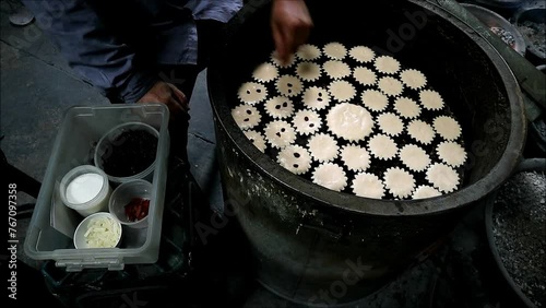 Footage of Baker Adding Raisins on the Mid-baked Batter of Khanom Farang Kudeejeen, a Famous Portuguese Influenced Cupcakes in Thailand photo