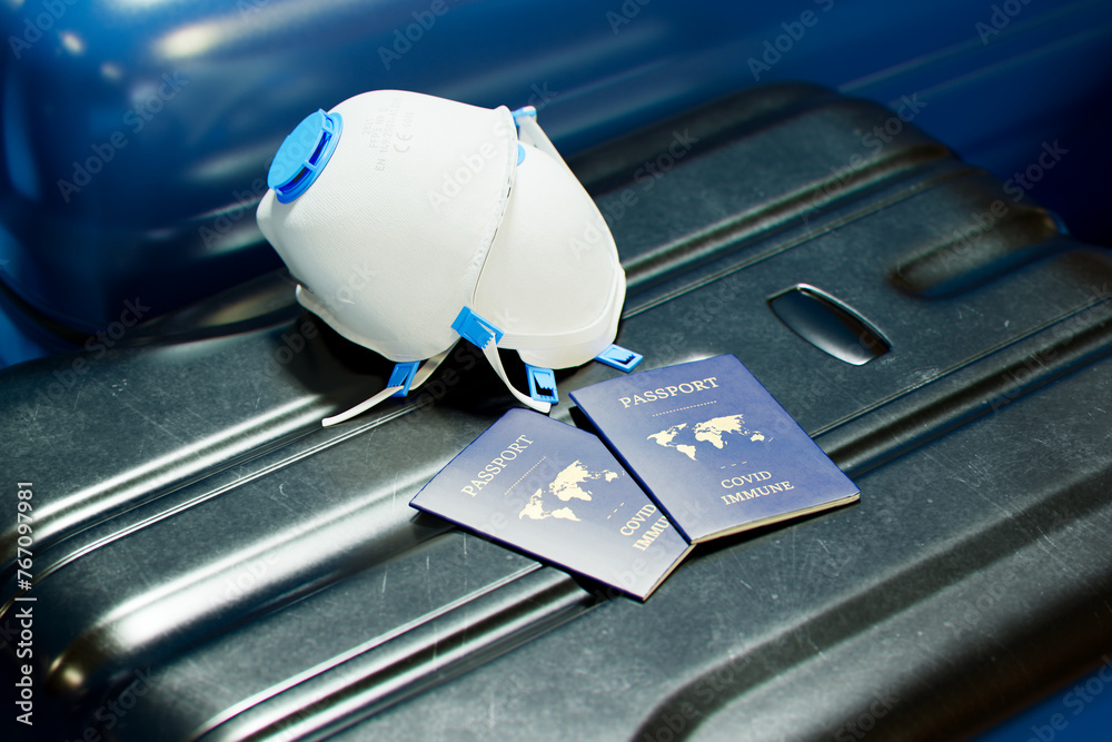 Obraz premium Pandemic Travel Preparedness: Passports, N95 Mask, and Suitcase Ready