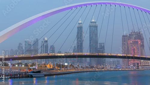 Fototapeta Naklejka Na Ścianę i Meble -  Pedestrian Bridge over the Dubai Water Canal day to night timelapse, United Arab Emirates