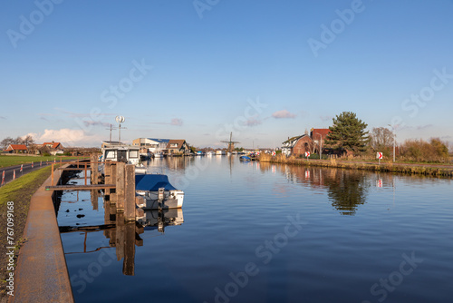 Boats and houses at the Ringvaart canal at the Lisserdijk in Lisse. On a sunny winter day in the Netherlands.