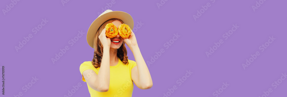 Summer portrait of happy woman with flower buds looking for something on purple studio background