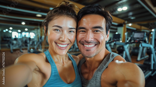 A man and a woman are smiling for a picture in a gym