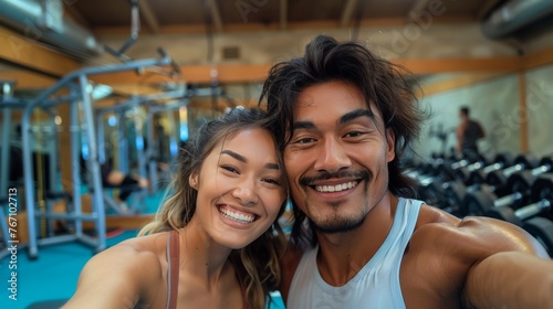 A man and a woman are smiling for a picture in a gym