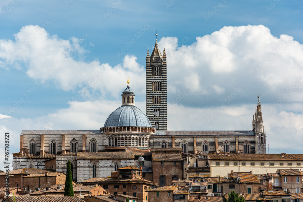 Fototapeta premium The historic city of Siena in the heart of Italy's Tuscany, with the famous cathedral of Santa Maria Assunta with its striped facade