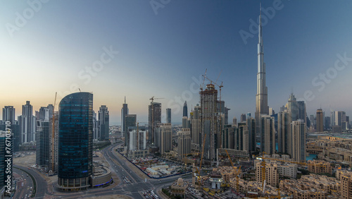 Dubai Downtown day to night timelapse. Aerial view over big futuristic city by night.