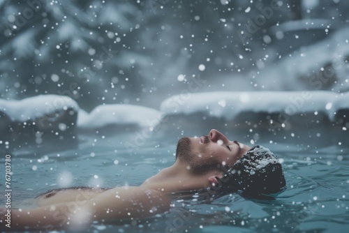 solo traveler relaxing in a natural hot pool during snowfall © studioworkstock