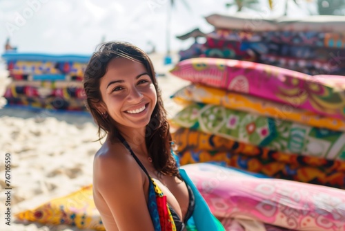 smiling woman in swimwear selling colorful sarongs on the beach