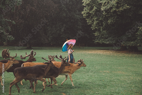 Girl Walking with Deer in Blatna Castle Park, Czech Republic photo