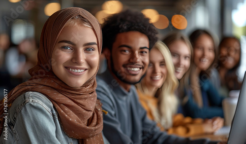 A group of people wearing head scarves are smiling and posing for a picture © hakule