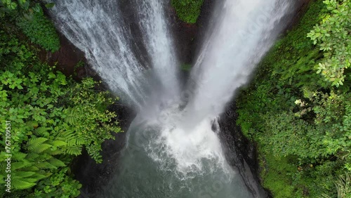 Rising up top view aerial slow motion footage of Aling Aling waterfall. Bali, Indonesia. photo