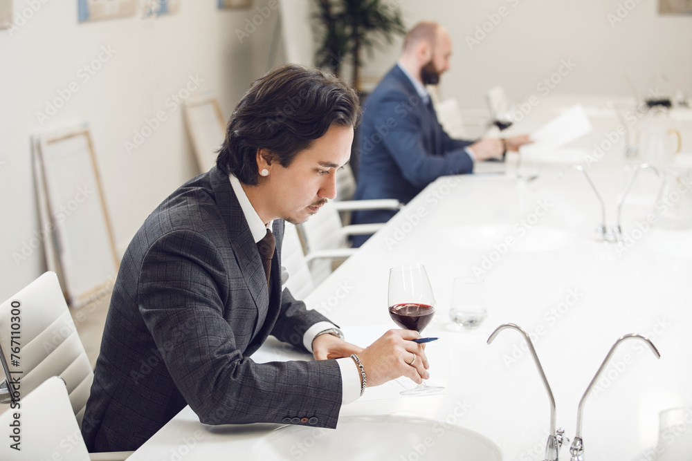 Sommelier Tasting Red Wine During Getting Exam For Worldwide Certification Sommelier Tasting Red Wine During Getting Exam For Worldwide Certification