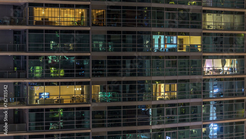 Glowing windows of skyscrapers at evening timelapse