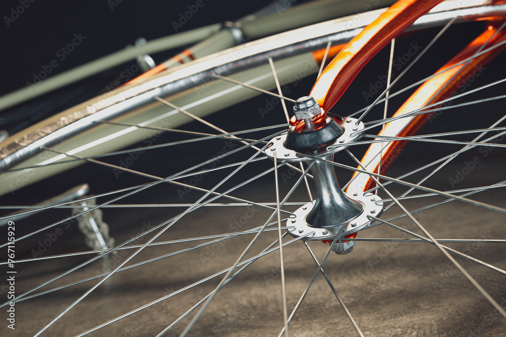 Detailed View of a Bicycle's Wheel Hub, Spokes, and Vibrant Orange Frame