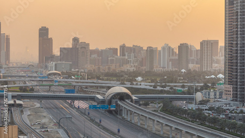 Aerial view of Jumeirah lakes towers skyscrapers during sunrise timelapse with traffic on sheikh zayed road.