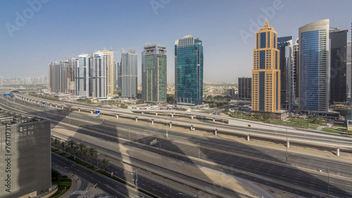 Aerial view of Jumeirah lakes towers skyscrapers timelapse with traffic on sheikh zayed road. © neiezhmakov