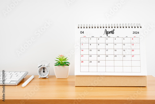 April 2024, Monthly desk calendar for 2024 year on wooden table.